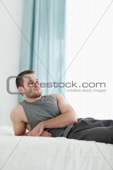 Portrait of a man posing on his bed