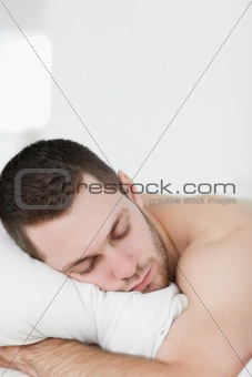Portrait of a man lying on his belly while sleeping