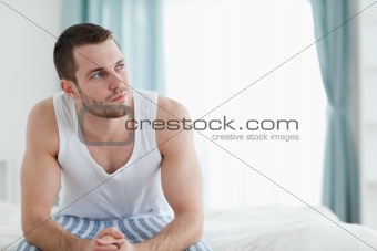 Quiet man sitting on his bed