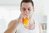 Attractive man drinking orange juice