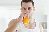 Serene man drinking orange juice