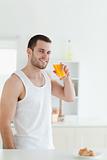 Portrait of a smiling man drinking orange juice