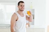 Smiling man drinking orange juice