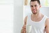 Smiling man drinking coffee
