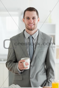 Portrait of a businessman having breakfast