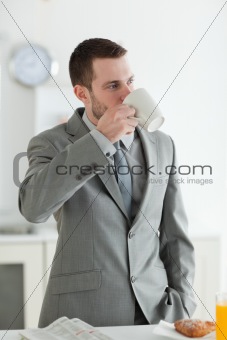 Portrait of a good looking businessman having breakfast