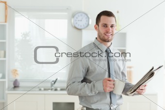 Businessman reading the news while having breakfast