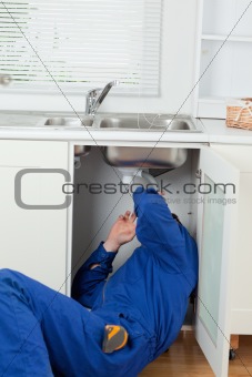Portrait of a plumber fixing a sink