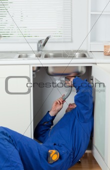 Portrait of a repairman fixing a sink
