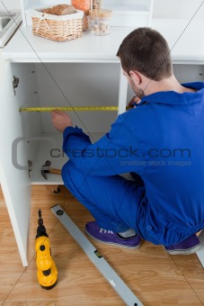 Portrait of a repair man measuring something
