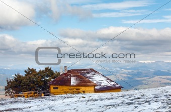 Wooden house on autumn mountain hill