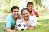 Grandfather With Son And Grandson In Park With Football
