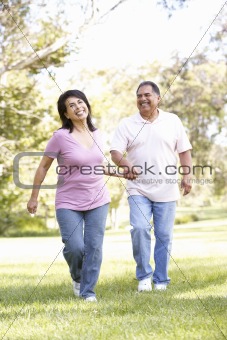 Senior Couple Running In Park