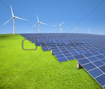 solar panels and wind turbines on the grass field