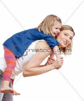 happy mother giving her daughter piggy back ride - isolated on white