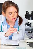 Busy female medical doctor working sample in laboratory
