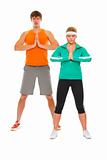 Fitness girl and man in sportswear doing yoga isolated on white
