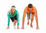 Healthy young man and fit female in start position ready for run race isolated on white

