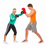 Fitness girl training boxing with help of personal trainer isolated on white
