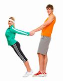 Slim young woman and male athlete having fun isolated on white
