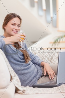Portrait of a woman having a glass of wine during a video conference