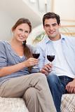 Portrait of a young couple having a glass of red wine