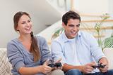 Smiling couple playing video games