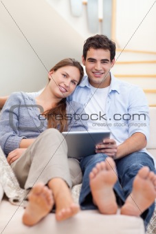 Portrait of a young couple using a tablet computer
