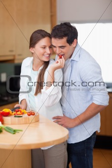Portrait of a woman feeding her husband