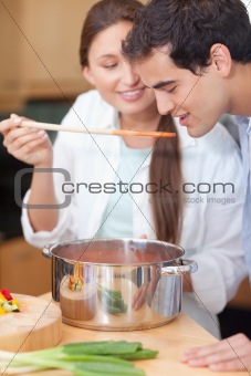 Portrait of a man trying his wife's sauce
