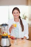 Portrait of a young woman drinking fresh fruits juice