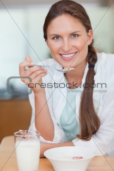 Portrait of a young woman having breakfast