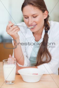 Portrait of a calm woman having breakfast