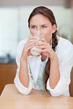 Portrait of a happy woman drinking milk
