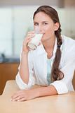 Portrait of a cute woman drinking milk