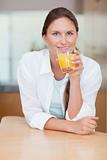 Portrait of a smiling woman drinking juice