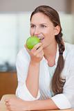 Portrait of a cute woman eating an apple