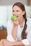Portrait of a lovely woman eating an apple
