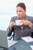 Portrait of a serious businesswoman drinking tea