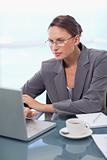 Portrait of a focused businesswoman using a laptop