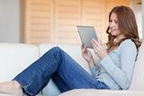 Woman reading e-book on the sofa
