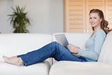 Smiling woman with laptop on the couch