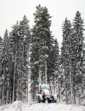 Tractor in winter forest