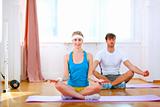 Healthy couple doing yoga at home
