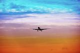 Passenger plane takes off at sunset