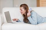 Female online shopper on her sofa
