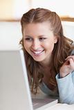Close up of smiling female using her laptop