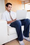 Male with laptop on the sofa