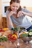 Woman flavouring the ingredients of her meal