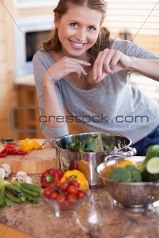 Woman adding some spices to her meal